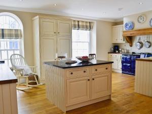 a kitchen with a island with a bowl on it at Awelfa - On7 in Aberaeron +22 photos