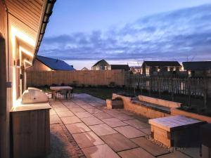 a patio with a bench and a table in a backyard at White Swan Cottage - Ukc4640 in Dunholme