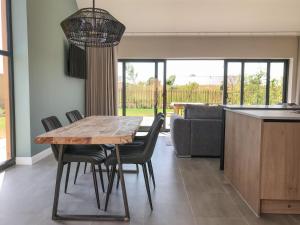 a dining room with a wooden table and chairs at White Swan Cottage - Ukc4640 in Dunholme +3 photos