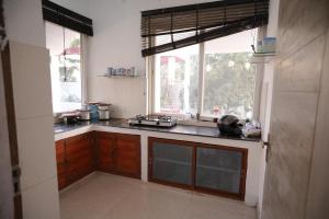 a kitchen with a counter top and a window at royal palace and resort in Sultānpur