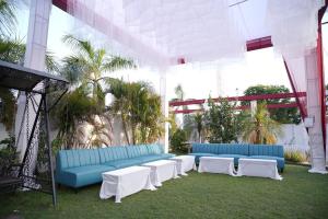 a group of blue and white couches in a building at royal palace and resort in Sultānpur