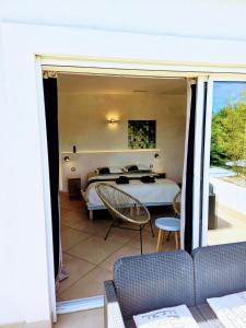 a bedroom with a bed and a balcony at Villa Perle De La Mer in Saint-Aygulf