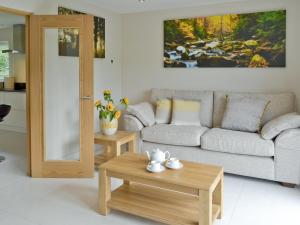 a living room with a couch and a coffee table at Honey Pippin in Cheriton Bishop