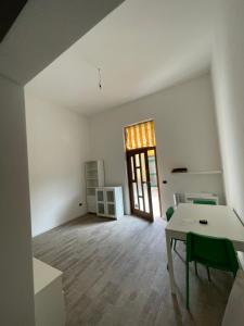an empty white room with a table and a door at Teodolinda in Trezzo sullʼAdda +13 photos