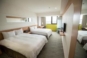 Llit o llits en una habitació de Ximen Relite Hotel