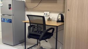 a black chair sitting next to a desk in a kitchen at شقق وردة الخرج in Al Kharj