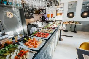 a buffet line with many different types of food at Hotel M4 Boutique in Krakow