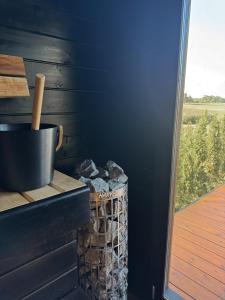 a black wall with a basket of rocks next to a door at Green Field Villa in Kuressaare