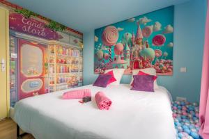 a bedroom with a large bed with a disney castle mural at Le Candy by Clem in Pélussin