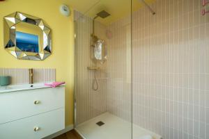 a bathroom with a shower and a sink and a mirror at Le Candy by Clem in Pélussin +18 photos