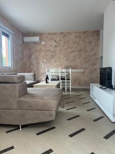 a living room with a couch and a table at Green Oasis Budva in Prijevor