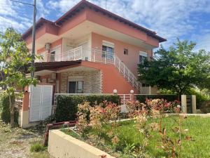 a house with a garden in front of it at Theodora villas Portaria beach 2 in Paralia Dionysiou