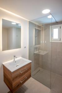 a bathroom with a sink and a shower at Apeiron Akrotiri - Apeiron Hotels in Akrotiri +46 photos