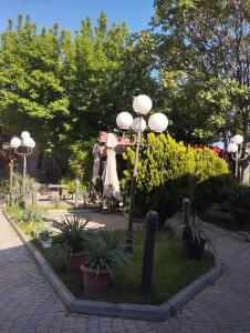 a group of street lights in a park with plants at The Corner Hotel in Yerevan