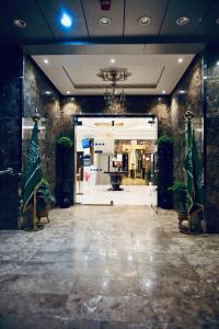 a store front with a large glass door with plants at روعة نجد القدس in Riyadh