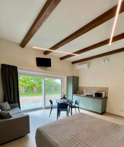 a living room with a bed and a table with chairs at Fermata Sessant in Asti +20 photos