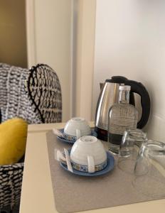 a table with a coffee maker and a tea kettle at Aqua Ria Boutique Hotel in Faro