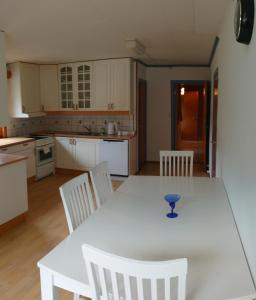 a kitchen with a white table and white chairs at Two bedroom Apartment 80m2 2nd floor in Bagn