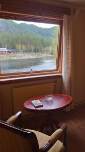a table and a window with a view of a river at Two bedroom Apartment 80m2 2nd floor in Bagn +5 photos