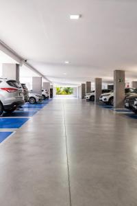 a garage with several cars parked in it at Jardins Almare Apart Hotel in João Pessoa