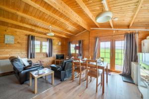 a living room with a table and a dining room at Moor View Cabin (Oak Tree Lane) in Okehampton