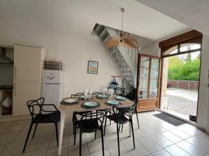 a kitchen and dining room with a table and chairs at "la brise marine",wifi&parking in Quend