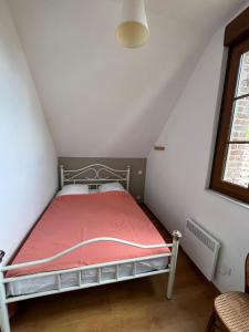 a small bedroom with a bed in a attic at "la brise marine",wifi&parking in Quend