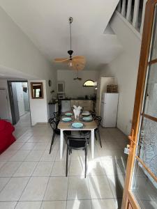 a dining room and kitchen with a table and chairs at "la brise marine",wifi&parking in Quend +3 photos
