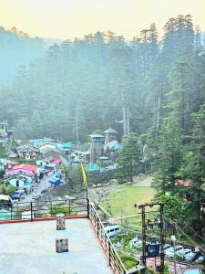 a view of a city with a park and trees at Hotal DESPRADES MRITYUNJAY INN in Jageshwar