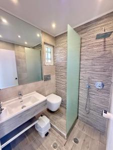 a bathroom with a sink and a toilet and a shower at Nissos Poros in Poros
