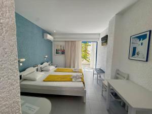 a bedroom with a bed and a table and a desk at Nissos Poros in Poros