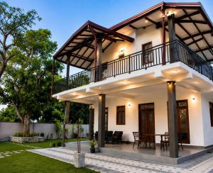 a house with a balcony and a patio at Araliya Villa in Tangalle +47 photos