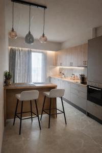 a kitchen with two stools and a wooden counter top at Memories in Tinos