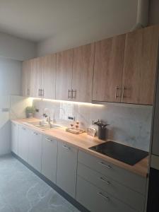 a kitchen with wooden cabinets and a sink at Memories in Tinos +2 photos