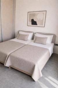 two beds sitting next to each other in a bedroom at Memories in Tinos