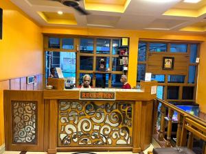 a lobby with people sitting at a reception desk at Arudhra Residency in Chidambaram