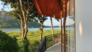 a balcony with a view of the water at Lakeside Echo Homestay in Kurunegala