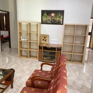 a living room with a couch and some shelves at Good Villa by Saran in Krabi