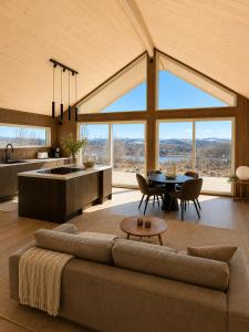 a living room with a couch and a table at Jarfjord Nature Escape in Herjenes