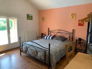 a bedroom with a bed in a room with orange walls at La Varenne in Changy +144 photos