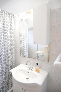 a white bathroom with a sink and a mirror at Piadora in Banjol +62 photos
