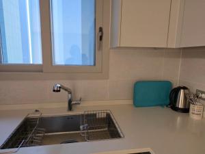 a kitchen counter with a sink and a window at 청라 스테이 22층 뷰 공항 송도 검단 김포 in Kojan +52 photos