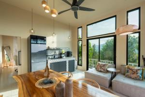a kitchen and living room with a table and chairs at Archie Paradise View in Thong Sala