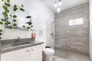 a bathroom with a toilet and a glass shower at Harmonia - Sunbeha resort, Juan Dolio in Juan Dolio +115 photos
