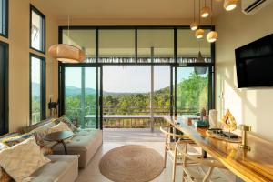 a living room with a couch and a table at Archie Paradise View in Thong Sala
