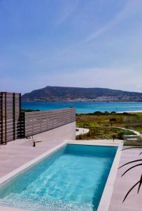 a swimming pool with a view of the ocean at Relaxury Villa I in Karpathos
