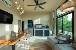 a living room with a ceiling fan and a table at Archie Paradise View in Thong Sala +65 photos
