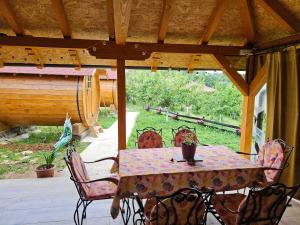 a table and chairs sitting on a porch with a table and chairs at Kucica in Lukavac