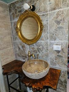 a bathroom with a sink and a mirror at Kucica in Lukavac