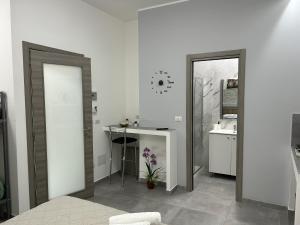 a bathroom with two sliding doors and a sink at La Pescheria - Mini Apartments in Catania